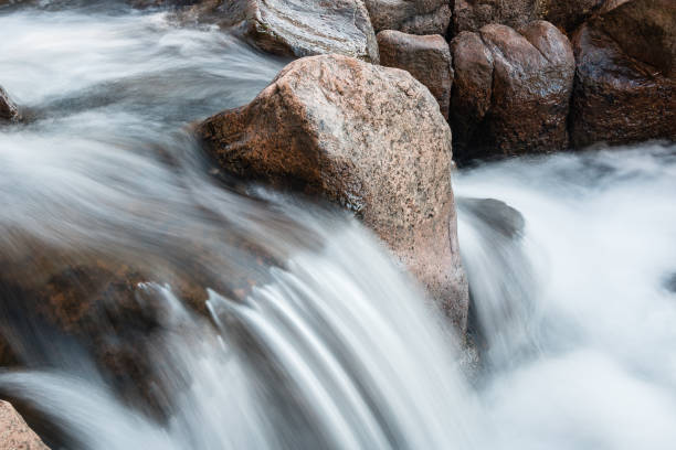 istock Rushing River Water With Large Rocks and Boulders 911904706