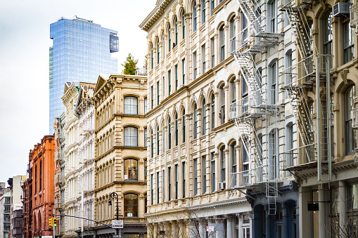 New modern building rises above the old historic buildings of SoHo in Manhattan, New York City