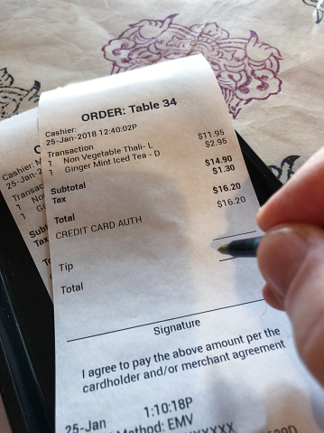 Paying Restaurant Bill with pen for dinner
