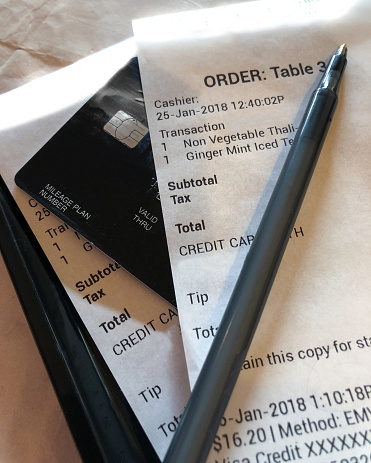 Paying Restaurant Bill with pen for dinner