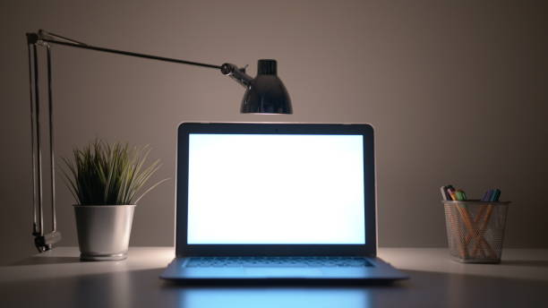 istock Laptop with a White Screen on the Table at Night 911918668