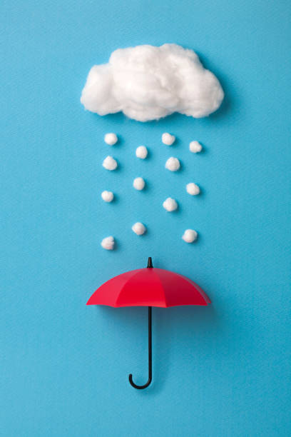 istock red umbrella under the cloud on sky blue background 911921924