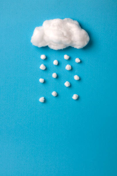 istock cotton cloud and snowflakes on sky blue background 911921928