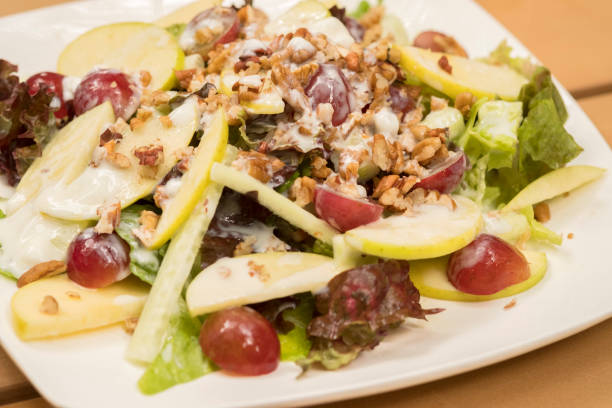 istock Fresh Vegetable and Fruit Salad with Walnuts on White Plate, Mexico 911922076
