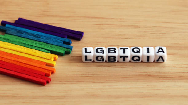 istock Multi colored stick  and LGBTQIA cube on the wood background. 911925138