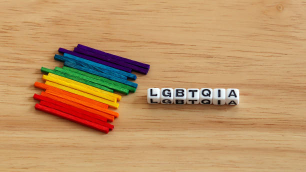 istock Multi colored stick  and LGBTQIA cubes on the wood background. 911925200