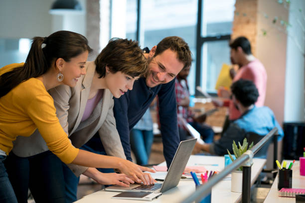 istock Casual business team working online at a creative office 911928586
