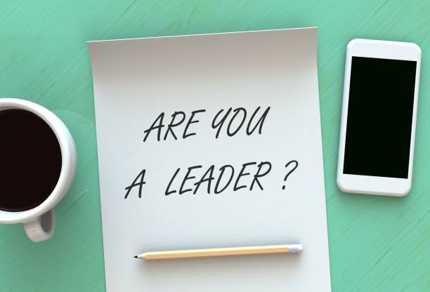 istock ARE YOU A LEADER, message on paper, smart phone and coffee on table, 3D rendering 911928644
