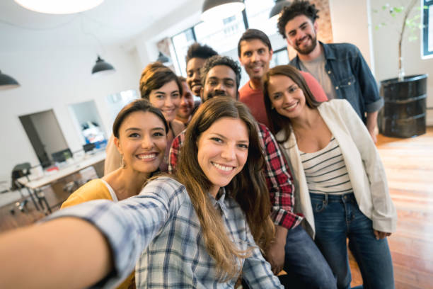 istock Happy group of coworkers taking a selfie at a creative office 911928696