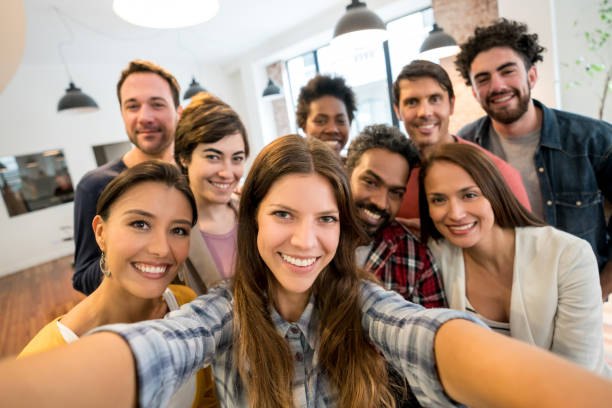 istock Happy group of coworkers taking a selfie at a creative office 911928700