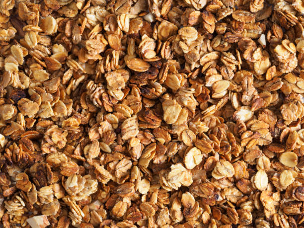 homemade granola texture Organic homemade Granola Cereal with oats and almond. Texture oatmeal granola or muesli as background. Top view or flat-lay. Copy space for text. granola photos stock pictures, royalty-free photos & images