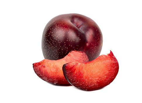 Tasty red plum with two slices on a white background