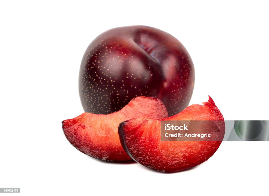 Red plum with slice Tasty red plum with two slices on a white background Plum Stock Photo