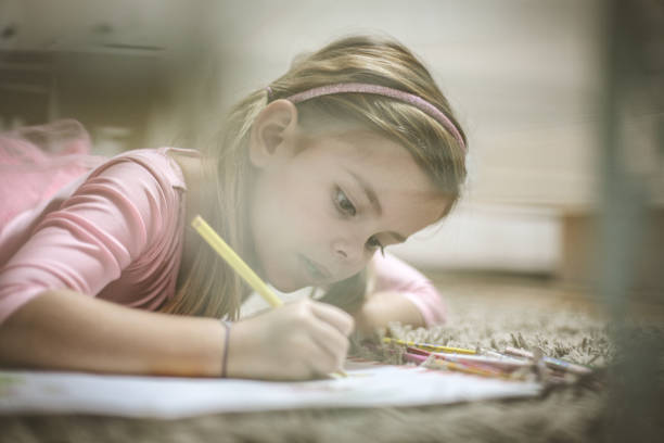 istock Preschool girl drawing. 911933432