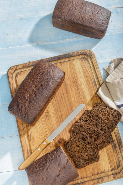 istock Top view sliced rye bread on wooden blue surface 911933640