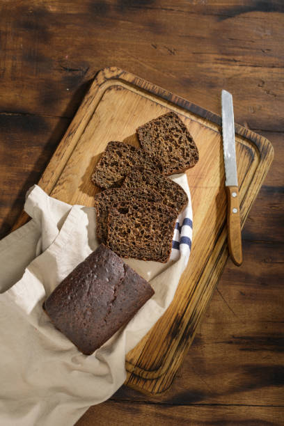 istock Sliced rye bread on dark surface close up, top view 911933906