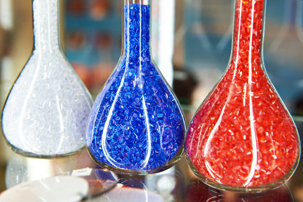 Colorful plastic granular polymer in glass flasks