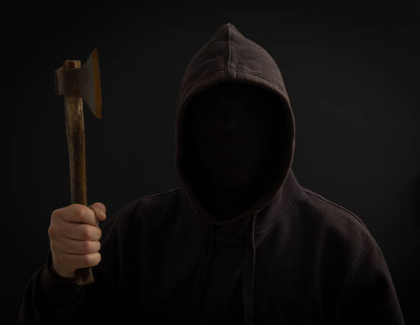 istock A killer with a hatchet in his hand in the dark 911941382