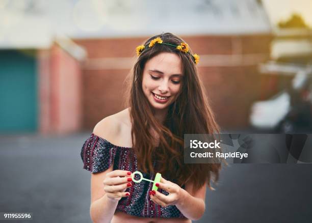 Beautiful Teenager Blowing Bubbles Outside Holds Bubble Wand Smiling Stock Photo - Download Image Now