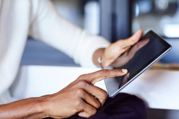 istock Cropped image of businessman using digital tablet 911961970