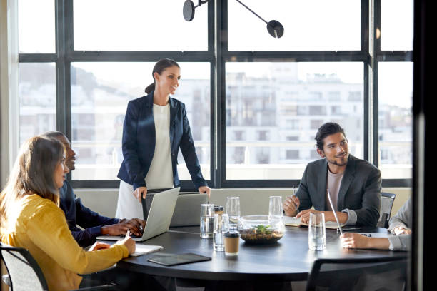 istock Smiling people in board room seen through glass 911963936