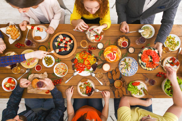 istock People eat healthy meals at served table dinner party 911964574