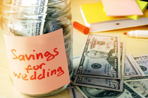 istock Savings for wedding concept. Jar with dollars and stick. 911964594
