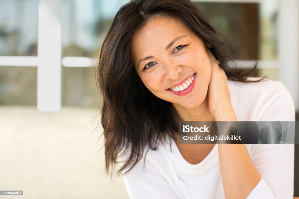 Portrait of an Asian woman smiling. Portrait of an Asian woman laughing and smiling. Women Stock Photo