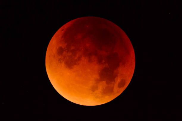 Blood moon - full Lunar Eclipse in the night sky stock photo