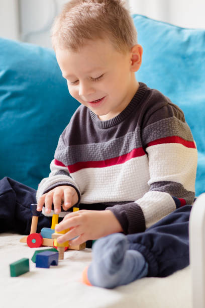 istock Boy playing weth wooden blocks 911970894