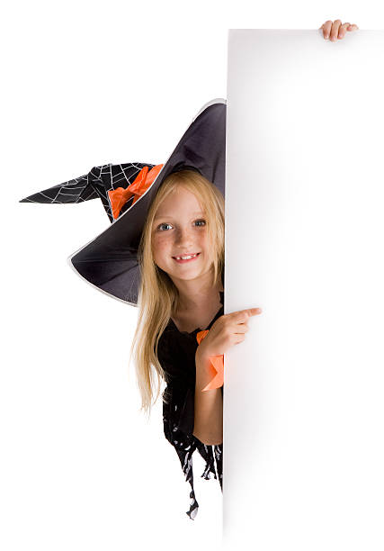 istock Little girl dressed as a playful witch, holding a blank sign 91197355