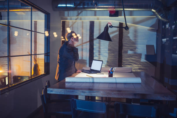 istock Working late. Senior businessman with beard working late on new project in his design studio 911974262