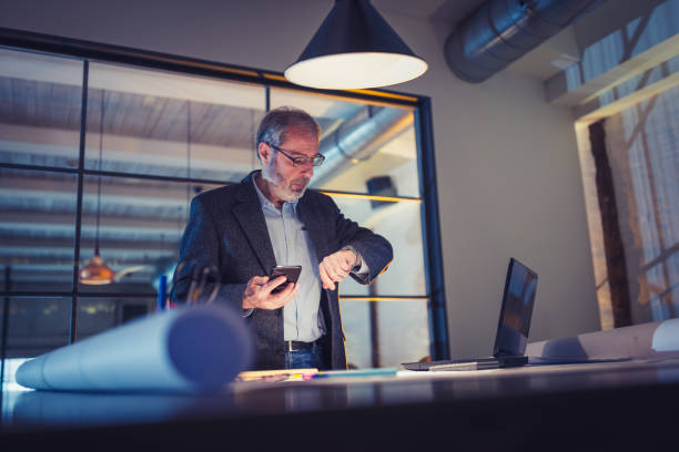 istock Working late. Senior businessman with beard working late on new project in his design studio 911974290