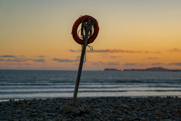 Lifebelt in the evening light on the pebble beach of Newgale, Pembrokeshire, Dyfed, Wales, UK