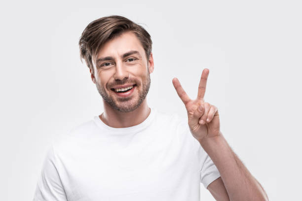 istock man showing victory sign 911974652
