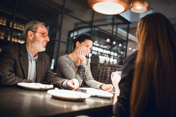 istock Businesspeople having meeting in in high end restaurant 911977656