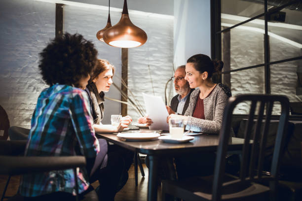 istock Businesspeople having meeting in in high end restaurant 911977772