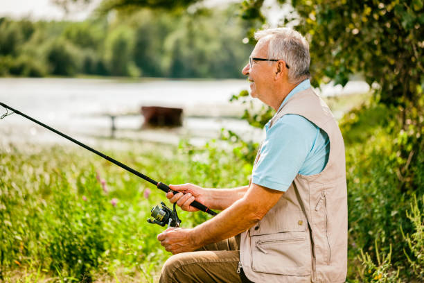 istock Senior man fishing 911979400