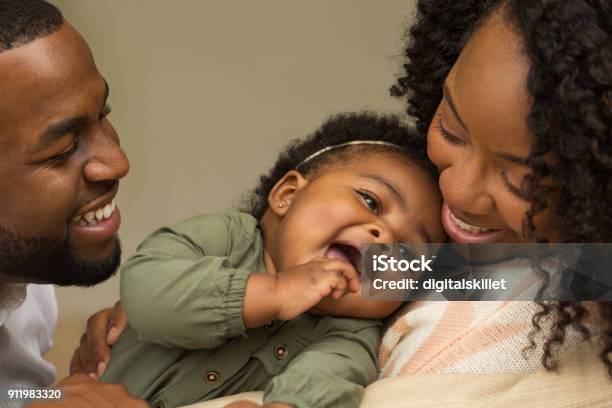 Happy African American Family With Their Little Girl Stock Photo - Download Image Now