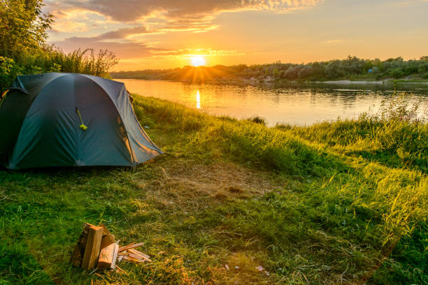 istock Camping tent in a camping on the river bank 911987402