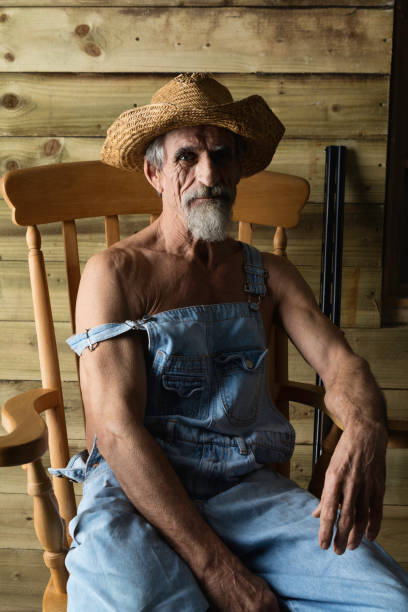 istock Hick in bib overalls and straw hat 911987916