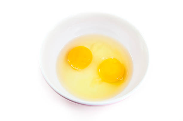 istock Egg yolks raw in a bowl  top view on  white 911988584