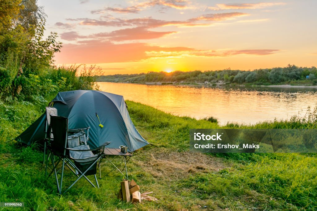 Camping tent in a camping in a forest by the river Camping tent in a camping in a forest by the Oka river. Russia Camping Stock Photo