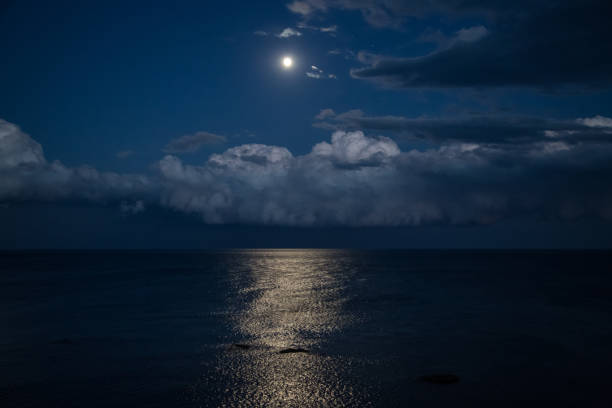istock Night sky with full moon and reflection in sea, beautiful clouds. 911995952