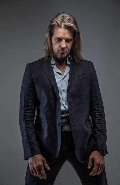 istock Long hairs middle age male in a suit. 911996046