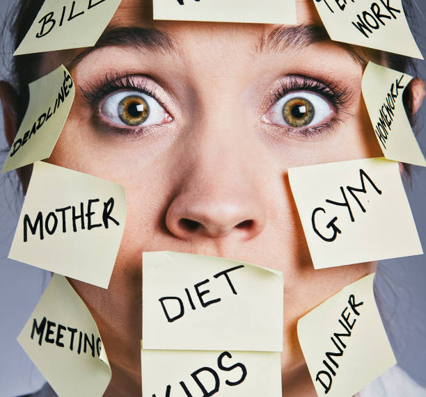 istock Wide-eyed woman covered in adhesive note tasks 911996598
