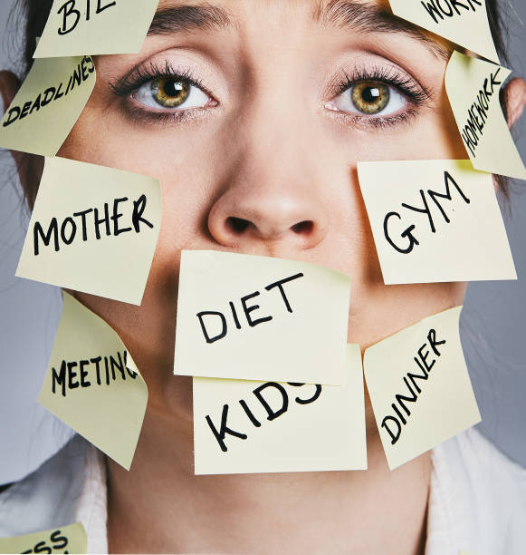 istock Exhausted woman covered in sticky-note chores cannot cope 911996766