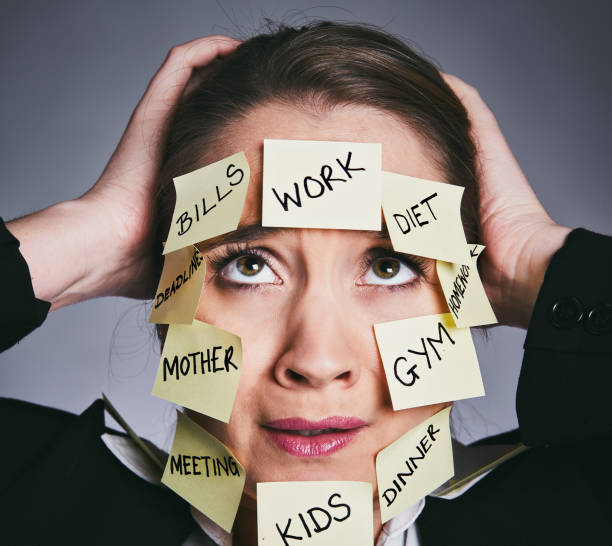 istock Beautiful woman with multiple task notes tears hair out 911999146