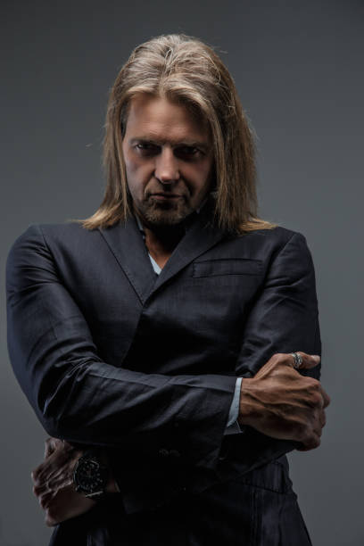 istock Long hairs middle age male in a suit. 911999598
