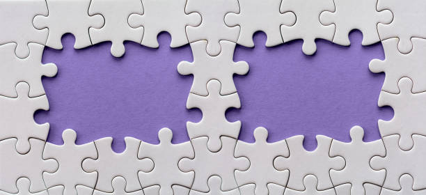 istock Unfinished purple holes in a blank jigsaw puzzle 911999662